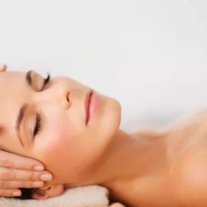 spa, resort, beauty and health concept - beautiful woman in spa salon getting face treatment